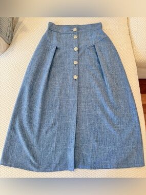 Denim color midi skirt with gold button detail